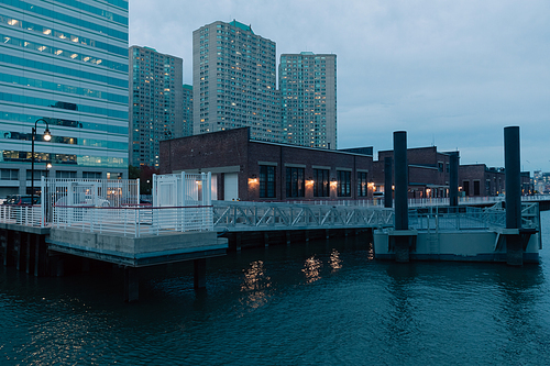 port and pier on Hudson river near modern buildings in New York City