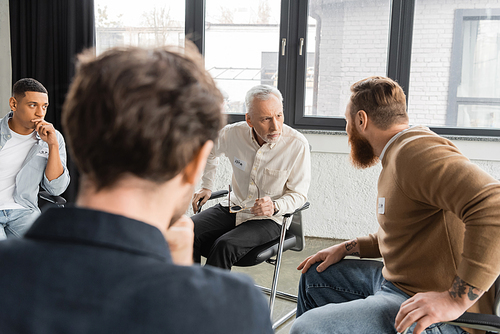 Man with alcohol addiction sharing problem during alcoholics meeting in rehab center