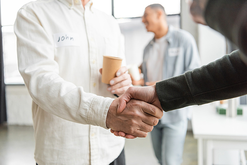 People with alcohol addiction shaking hands in recovery center