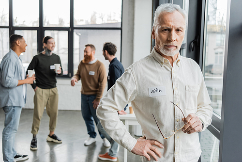 Mature man with alcohol addiction looking at camera in rehab center