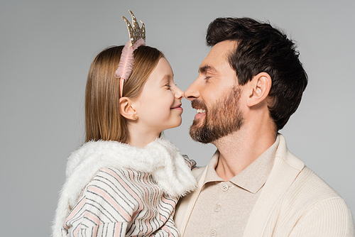 cheerful father and happy daughter touching noses isolated on grey