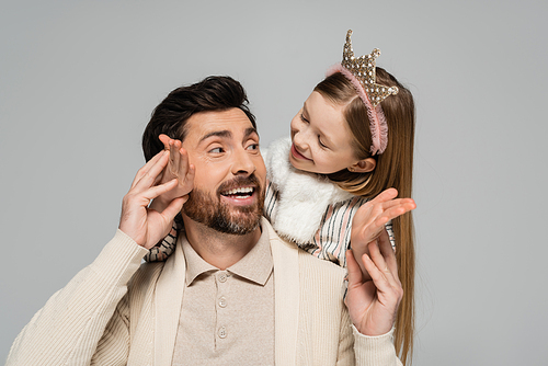 happy kid in crown hugging smiling father with beard isolated on grey