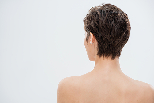 back view of young woman with short hair and bare shoulders isolated on grey