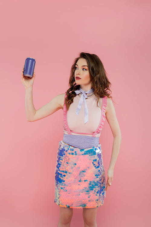 doll concept, attractive young woman with wavy hair holding soda can with carbonated drink, standing on pink background, fashion model in stylish outfit, femininity, doll pose, advertisement