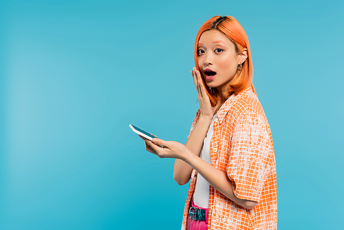 surprised face, social media influencer, young asian woman with dyed hair using smartphone on blue background, mobile phone, youth culture, digital age, messaging, generation z