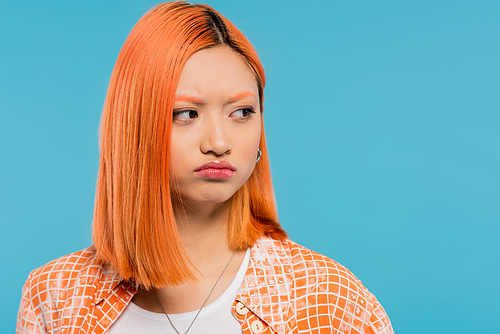 offended, displeased, upset, young asian woman with red hair looking away and pouting lips on blue background, casual wear, generation z, emotional, upset, sad face