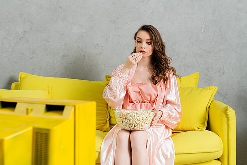 emotional stress, sad woman with smudged mascara sitting on yellow couch, housewife with crying eyes eating popcorn and watching tv, retro, depressed, heartbroken wife at home