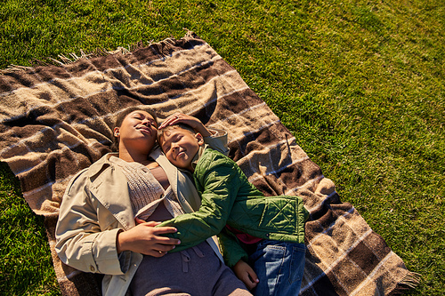 top view, happiness, motherly love, african american woman and son lying on blanket, autumn, grass