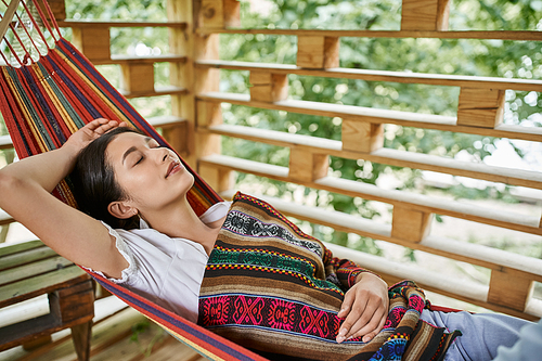 young attractive woman sleeping in hammock, relaxation, enjoyment, women retreat concept