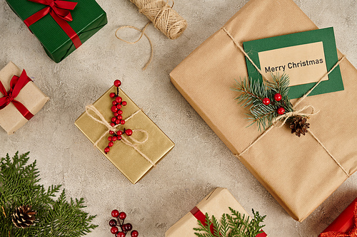 festive backdrop, Merry Christmas greeting card near gift boxes with pine branches and holly berries