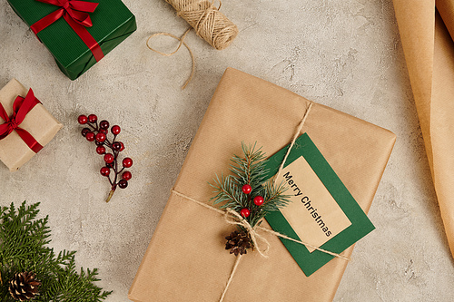 Christmas backdrop, Merry Christmas greeting card near presents with pine branches and holly berries