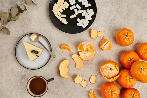 Christmas treats, pudding and marshmallows near hot chocolate on grey surface with tangerines