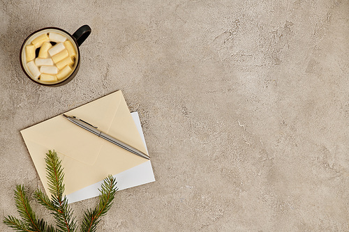 post envelopes and pen near pine branch and hot chocolate with marshmallows, Christmas backdrop