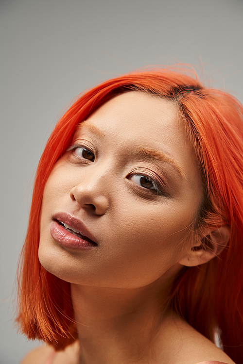 close up of asian beautiful woman with red hair and soft skin looking at camera, gracefulness