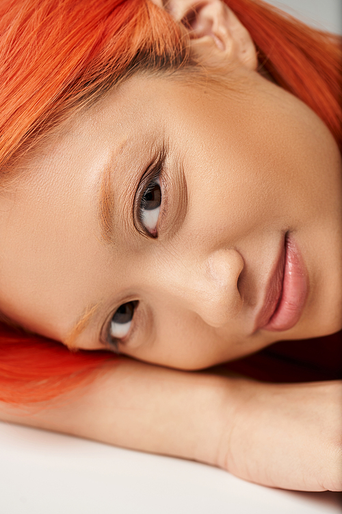 close up portrait of happy asian woman with perfect skin smiling on grey backdrop, feminine grace