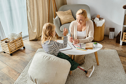 mother and child drawing on paper with colorful pencils and spending quality time together, banner