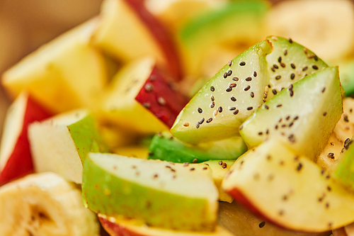 close up view of vegetarian salad with fresh fruits and honey with sesame seeds, culinary delight
