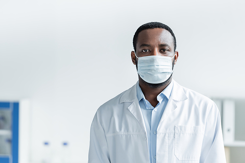 African american doctor in protective mask standing in hospital