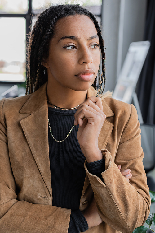 African american businesswoman in blazer looking away in office