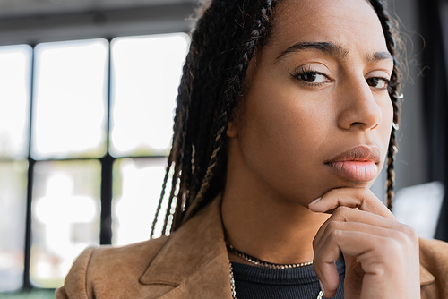 Portrait of serious african american businesswoman looking at camera in office