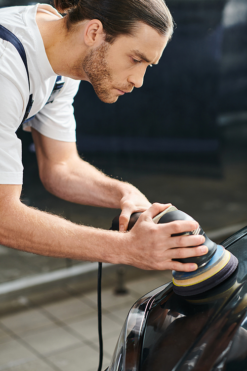 appealing hard working serviceman in comfy uniform with collected hair polishing black car