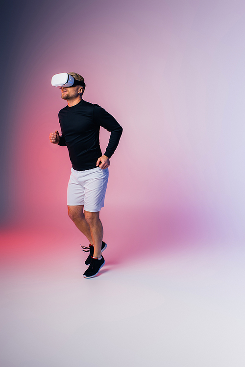 A man wearing a black shirt and white shorts moves gracefully in a studio setting, virtual reality