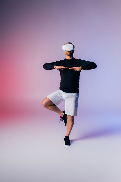 A man in a black shirt and white shorts executes a dynamic dance move, showing skill and passion in a studio setting.