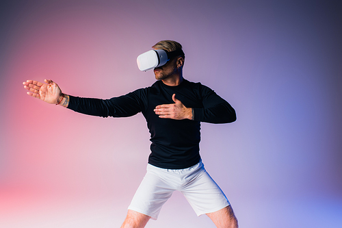 A man in black shirt and white shorts dancing gracefully in a virtual reality studio setting.