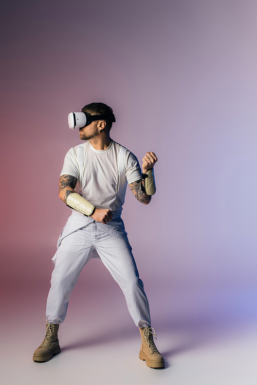 A man in a baseball uniform confidently grips a baseball bat, ready to take a powerful swing in a studio setting.