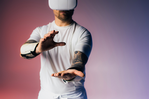 A man in a white shirt extends his hands in a gesture of openness and connection, bathed in soft studio lighting.