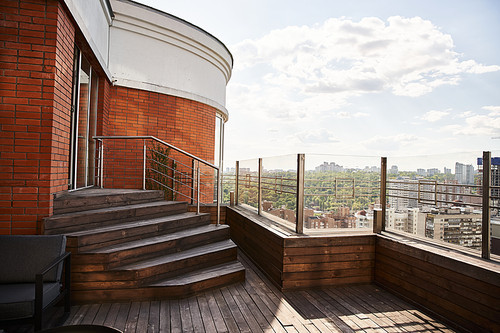 A balcony provides a breathtaking view of the cityscape below, showcasing the bustling urban life and towering skyscrapers