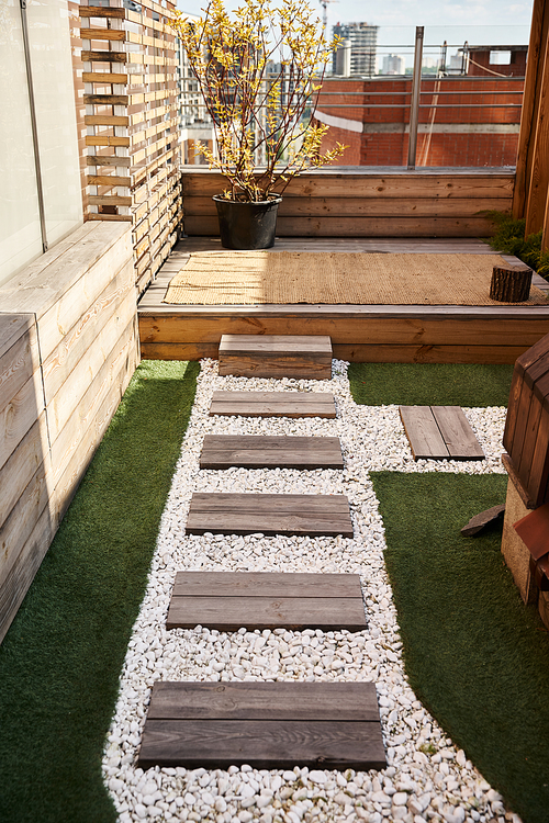 A peaceful backyard featuring a wooden deck and a charming garden filled with vibrant flowers and greenery