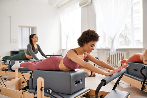 Sporty women practicing pilates in a gym.