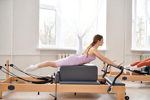 Fit woman exercising during a pilates lesson.