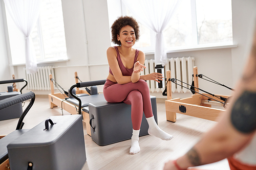 Beautiful women spending time together on pilates lesson in gym, relaxing.