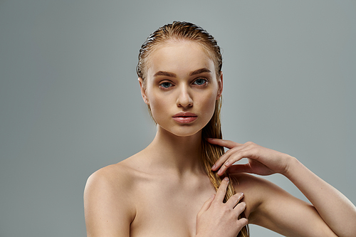 A graceful young woman with long, wet hair strikes a pose.