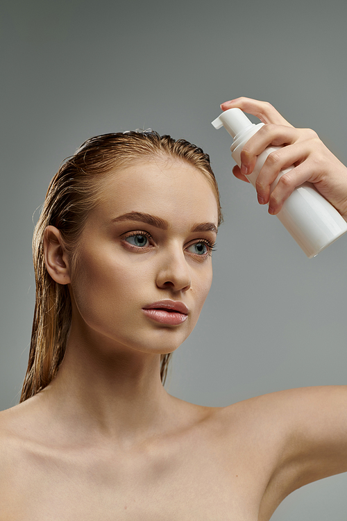 Woman holding lotion, caring for skin and hair.