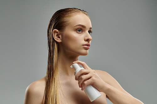 Attractive woman applying hair treatment.