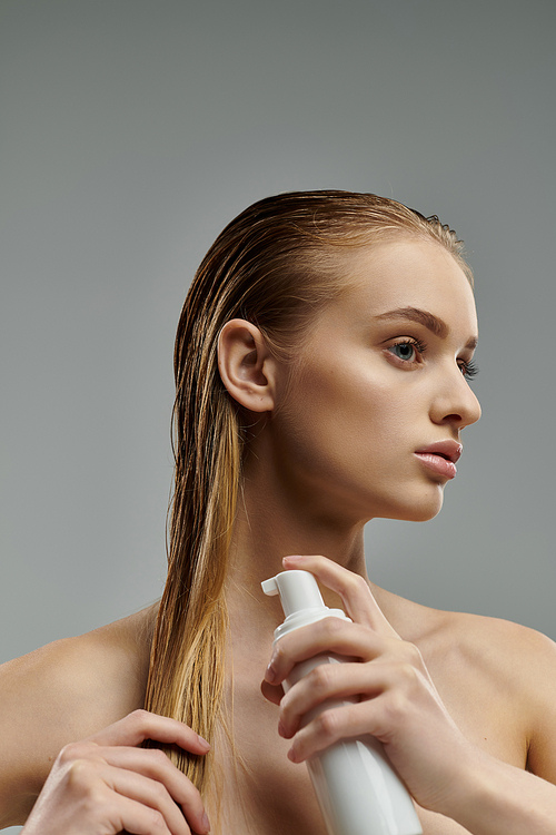 Appealing woman applying hair treatment.