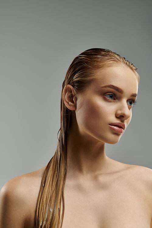 Young beauty demonstrates hair care with long, wet hair.