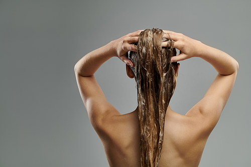 Pretty woman washing her hair.