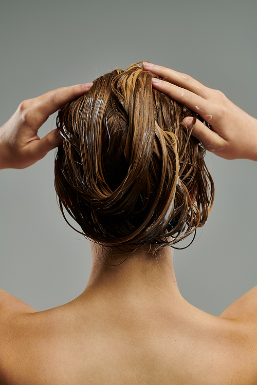 Sophisticated woman washing her hair.