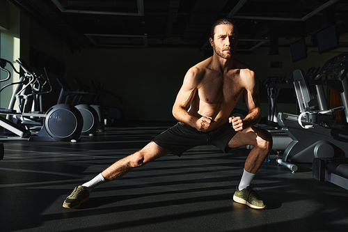 A shirtless muscular man working out in the gym, showcasing his toned physique and strength.