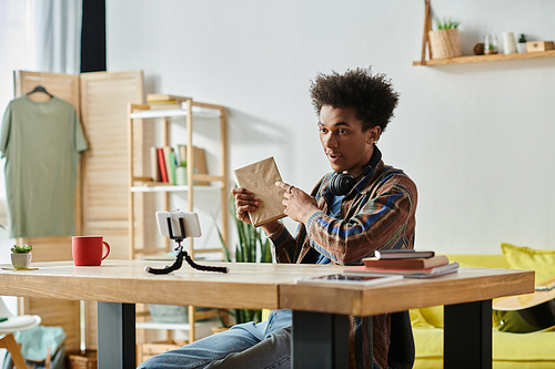 A man sitting at a table engrossed in a book.