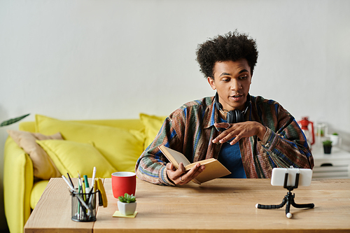 A man immersed in a book at a table.