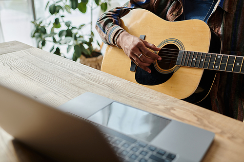 A guitarist strums passionately in front of a phone while connecting digitally.