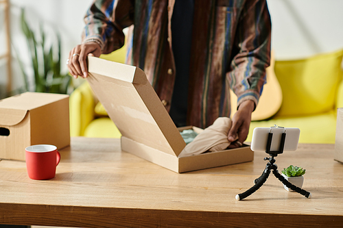 A man reveals the contents of a box on a table.