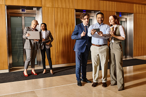 Multicultural group of business people standing together in elevator.