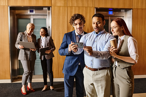 A diverse group of business professionals standing together in a circle.