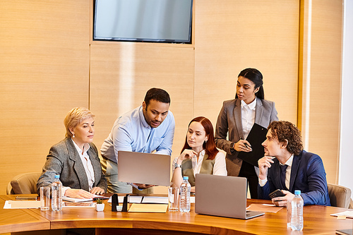 A diverse group of business people collaborate at a conference table.